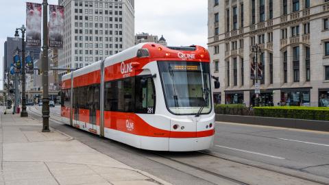 A red and white streetcar in downtown Detroit