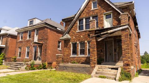 Two brick multifamily homes that need renovations