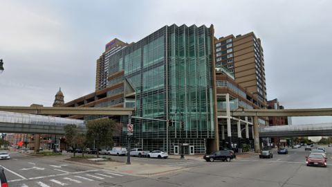 A corner building in downtown Detroit with an 8 story glass atrium