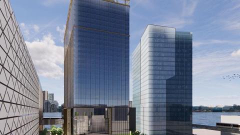 A rendering of two glass towers along a riverfront