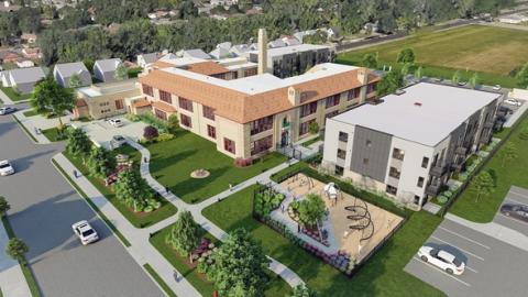 A rendering of a renovated school and new buildings for apartments